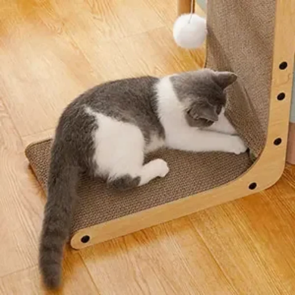 L-shaped cat scratcher: grey and white cat lying on an L-shaped cardboard cat scratcher